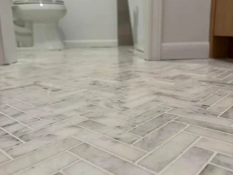 Close view of herringbone bathroom floor tile.