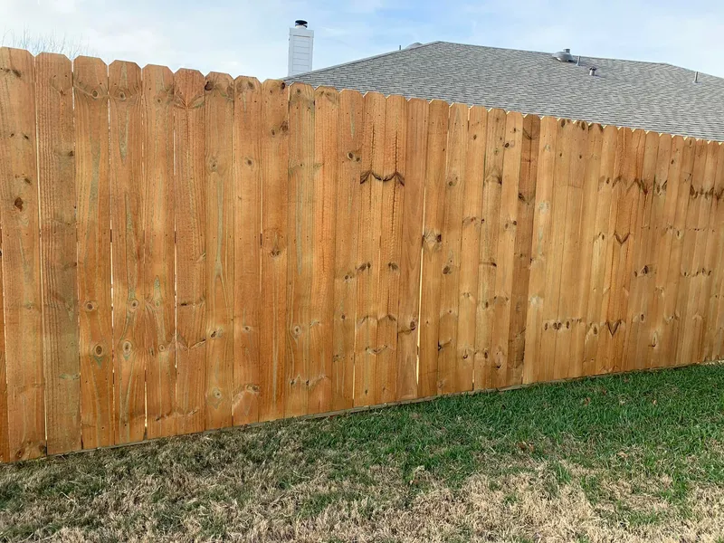 Close view of stained fence boards.
