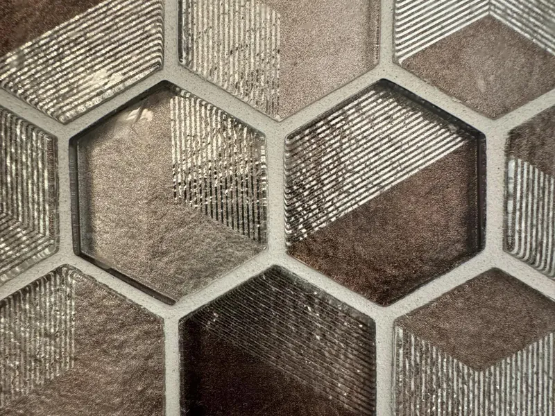 White hex mosaic tile detail from a bathroom.
