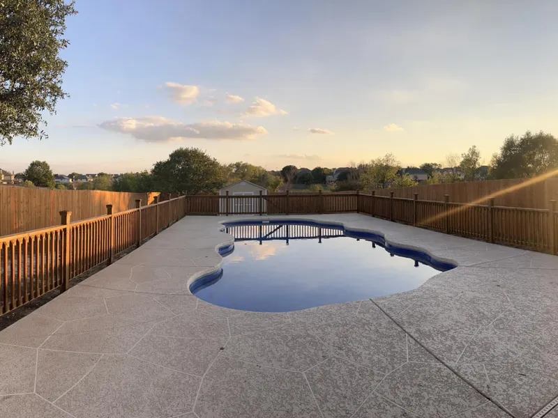 Stained fence, deck, and rail by Four L. The pool in frame is not our work.